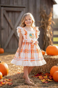 Scarecrow applique dress with embroidered hem.