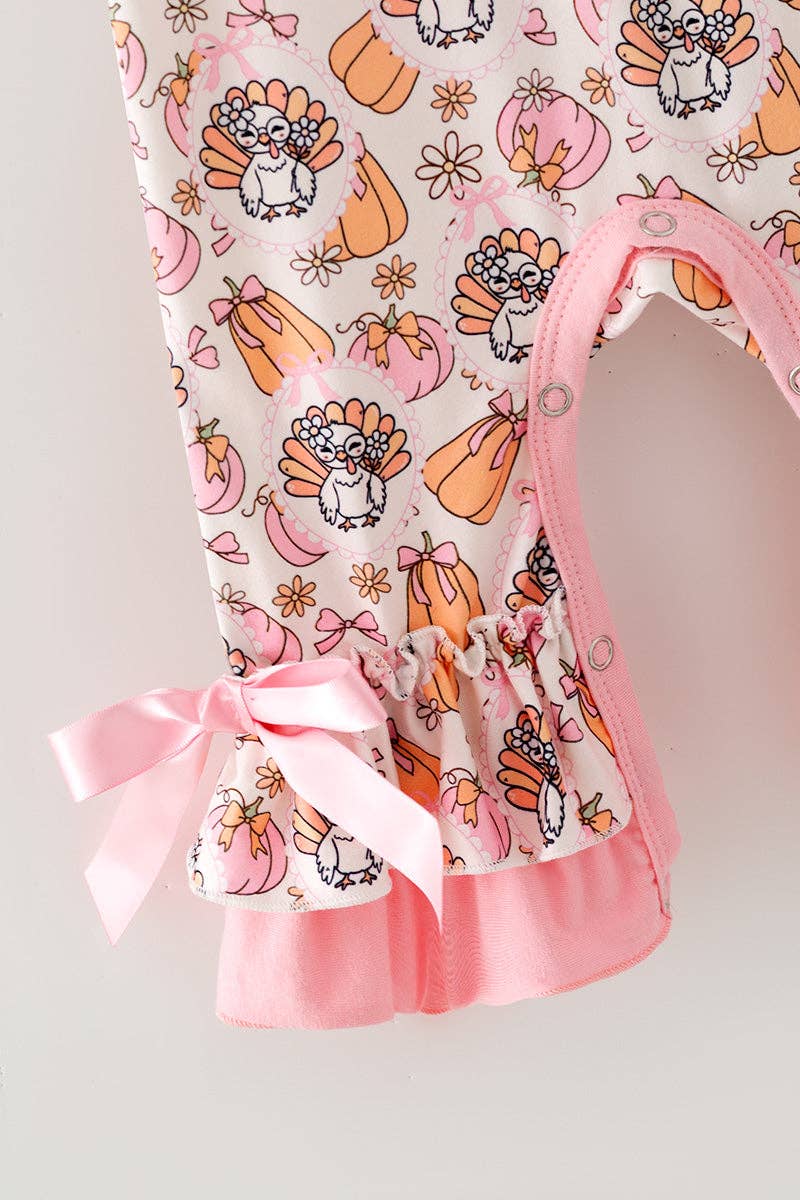 Turkey & pumpkin printed romper w/ pink ruffle hem.