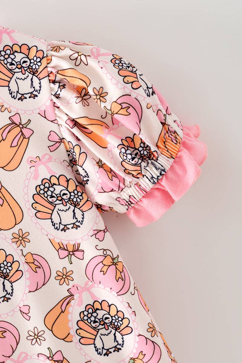 Turkey & pumpkin printed romper w/ pink ruffle hem.