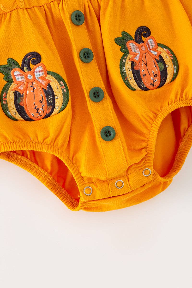 Pumpkin applique baby bodysuit with snaps.