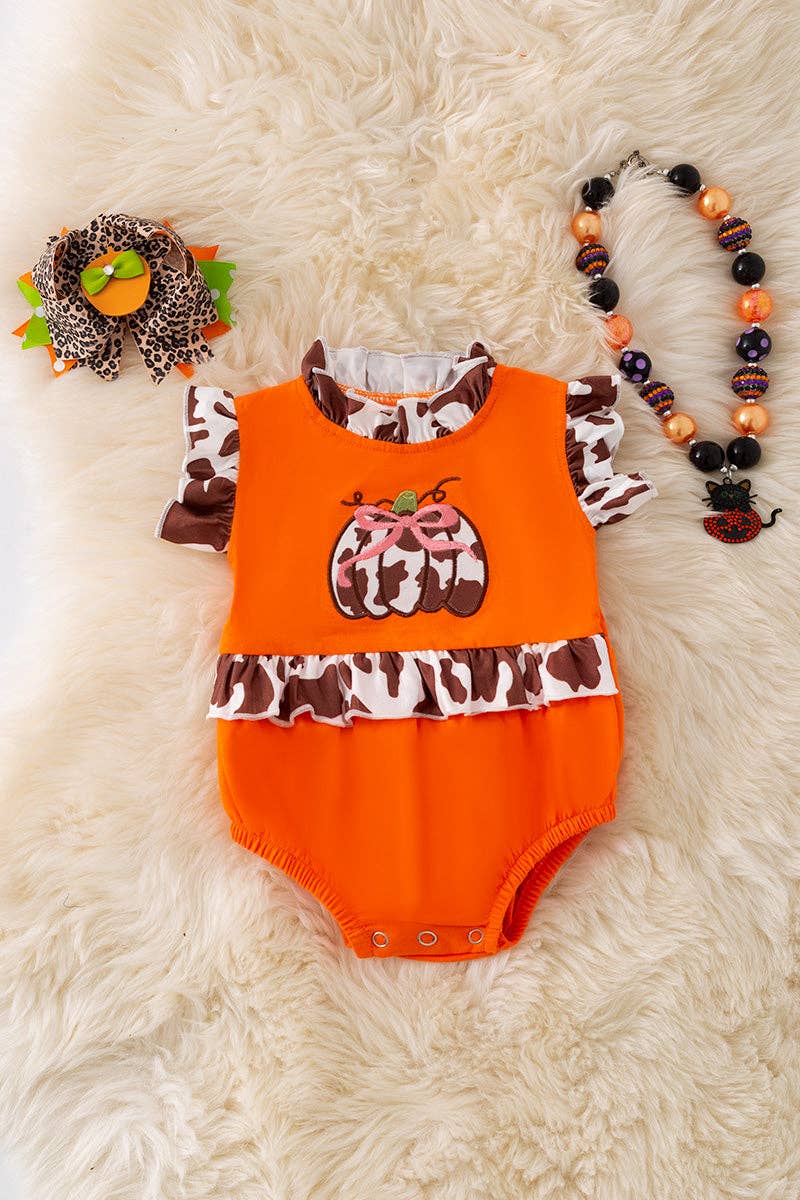 Cow printed pumpkin baby bodysuit .