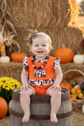 Cow printed pumpkin baby bodysuit .