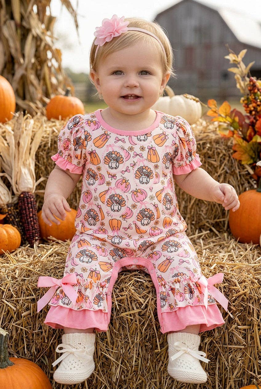Turkey & pumpkin printed romper w/ pink ruffle hem.
