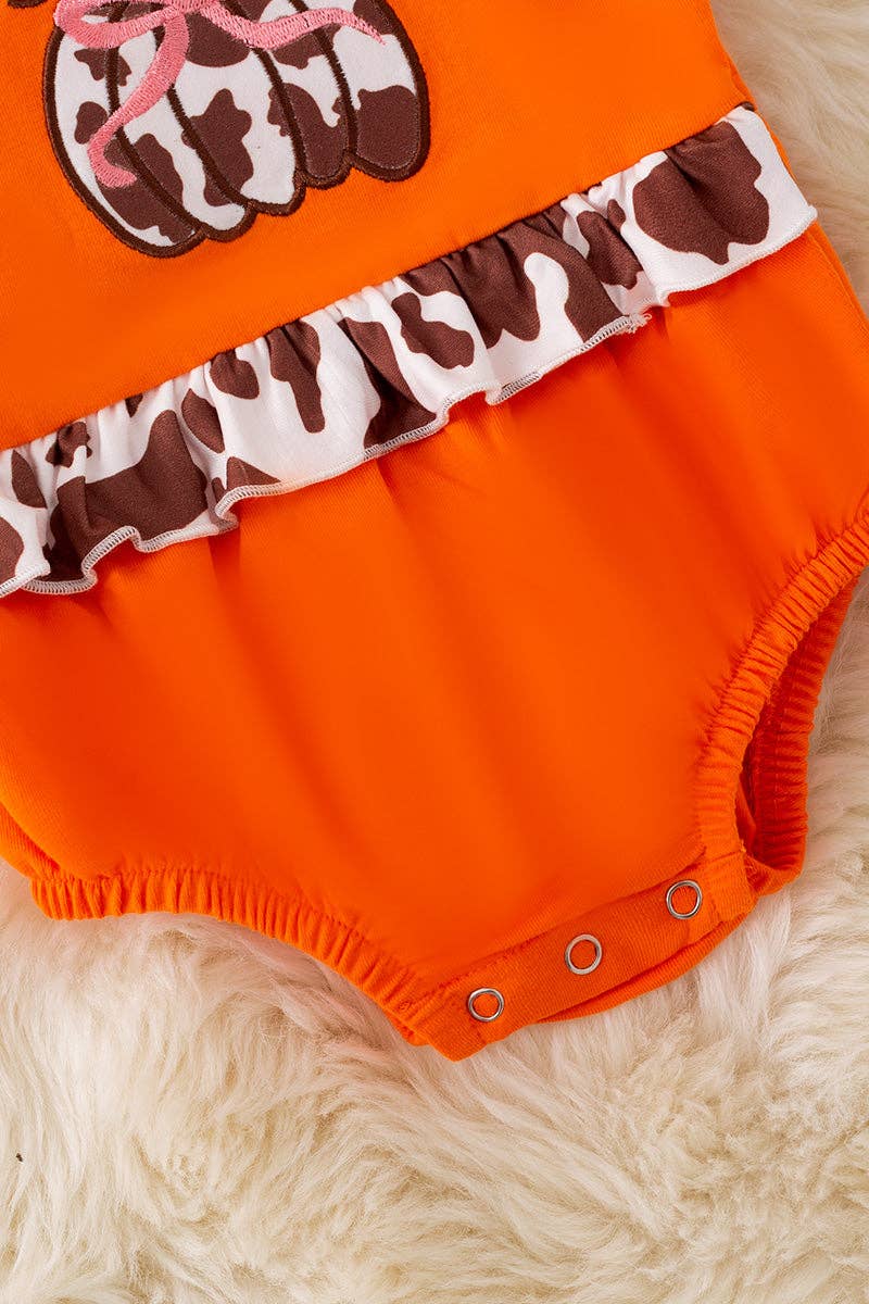 Cow printed pumpkin baby bodysuit .